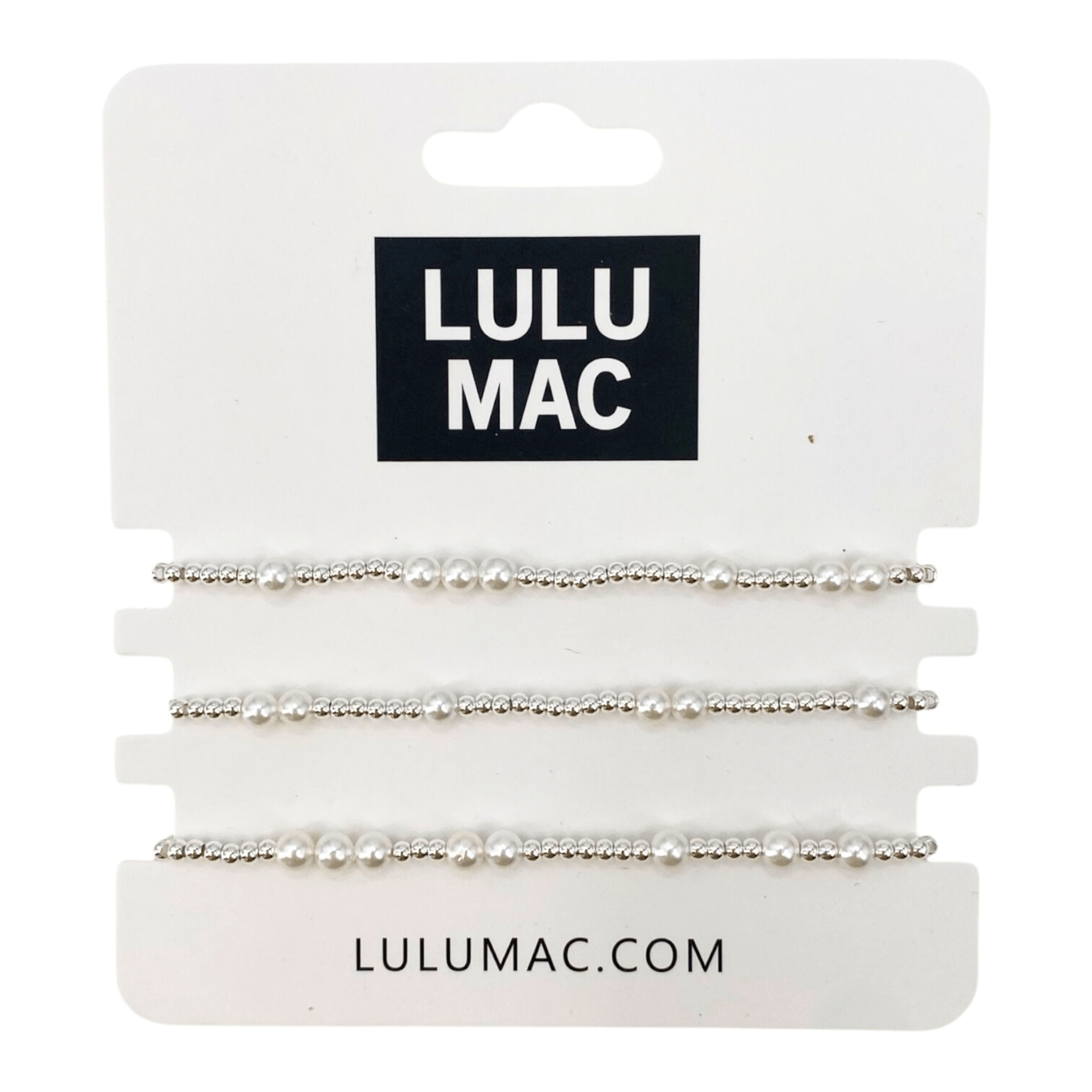 THE PEARL EDIT BRACELET SET BY LULU MAC features three silver-tone stretch bracelets with faux pearl accents.