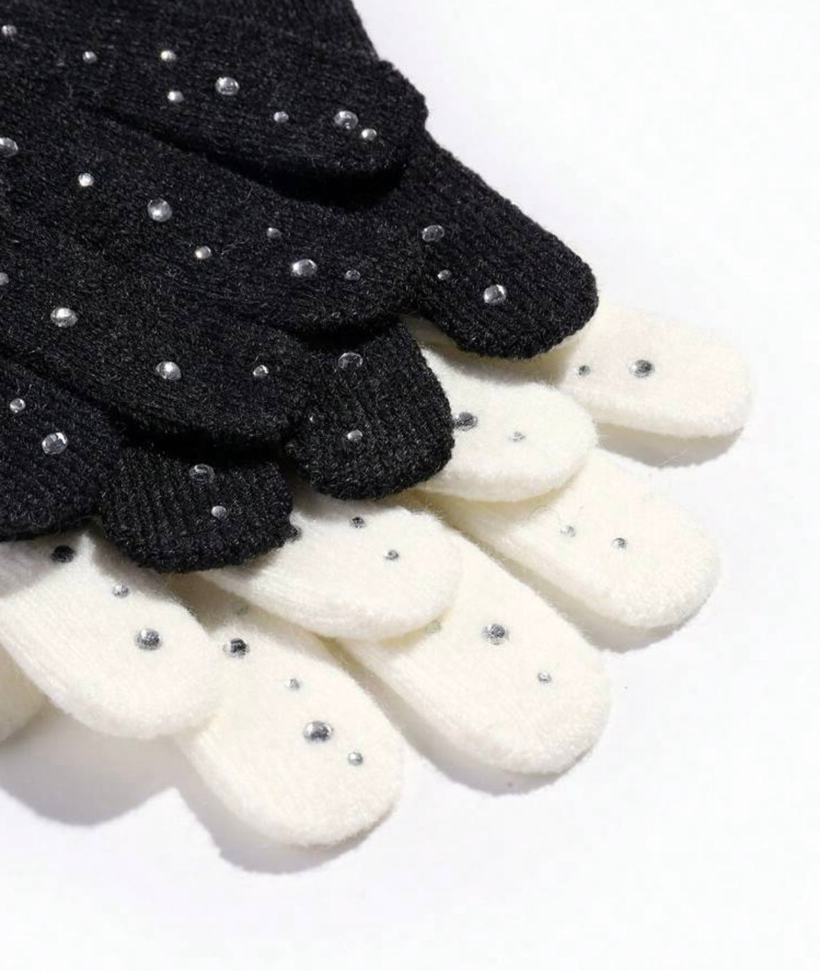 STILL BEJEWELED gloves in winter white and jet black with sparkly rhinestones for stylish warmth.