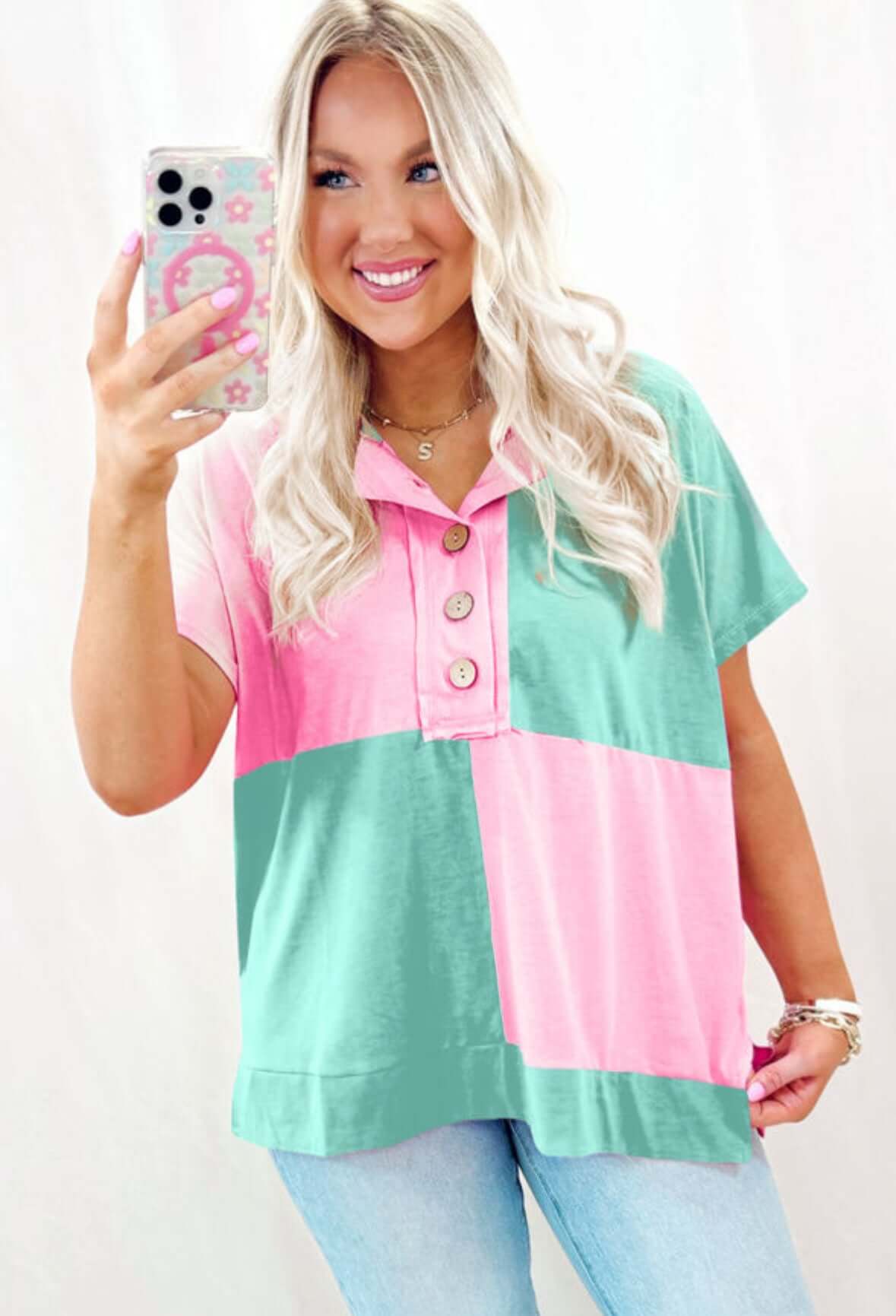 Stylish woman in pastel SUGAR RUSH top, smiling and taking selfie, featuring pink and green color blocking.
