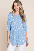 Model wearing the Sparks Fly Top, a relaxed blue tunic with a subtle star print, perfect for casual wear.