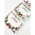 Cute Christmas Theme Sparkly Earrings displayed on festive card, featuring assorted Christmas designs including penguins, snowmen, and ornaments.