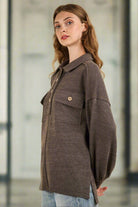 Model showcasing a NT11852X-PLUS collared button down Henley knit top with pockets and drop shoulder design.