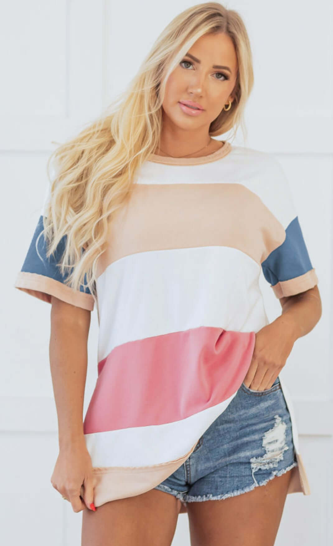 BOLD MOVES TOP featuring stripes in soft colors, styled with denim shorts for a trendy look.