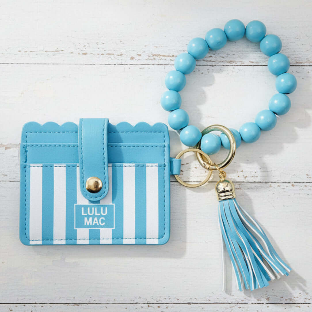 LULU MAC BLUE/WHITE WRISTLET with a beaded strap and tassel, perfect for stylish organization on-the-go.