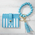 LULU MAC BLUE/WHITE WRISTLET with a beaded strap and tassel, perfect for stylish organization on-the-go.