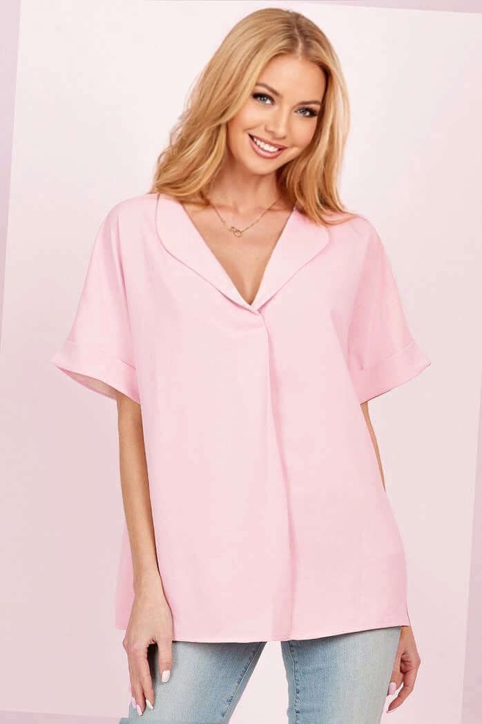 Beautiful model wearing a pink DAYBREAK DARLING top with a collared neckline and relaxed sleeves, perfect for casual outings.