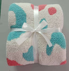 Soft microfiber throw blanket in vibrant colors, tied with a ribbon, perfect for cozying up at home.