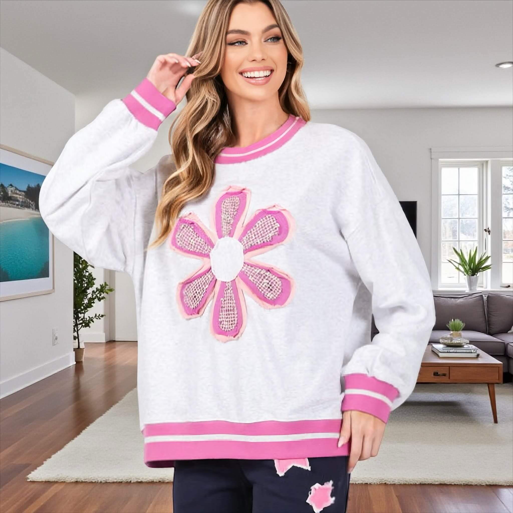 DAYDREAM BELIEVER - Sage + Fig (gray) oversized pullover with daisy appliqué worn inside a cozy living room.