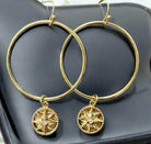 Natural Balance Earrings with gold tone circles and rhinestone-star center on French hook, capturing nature's beauty.