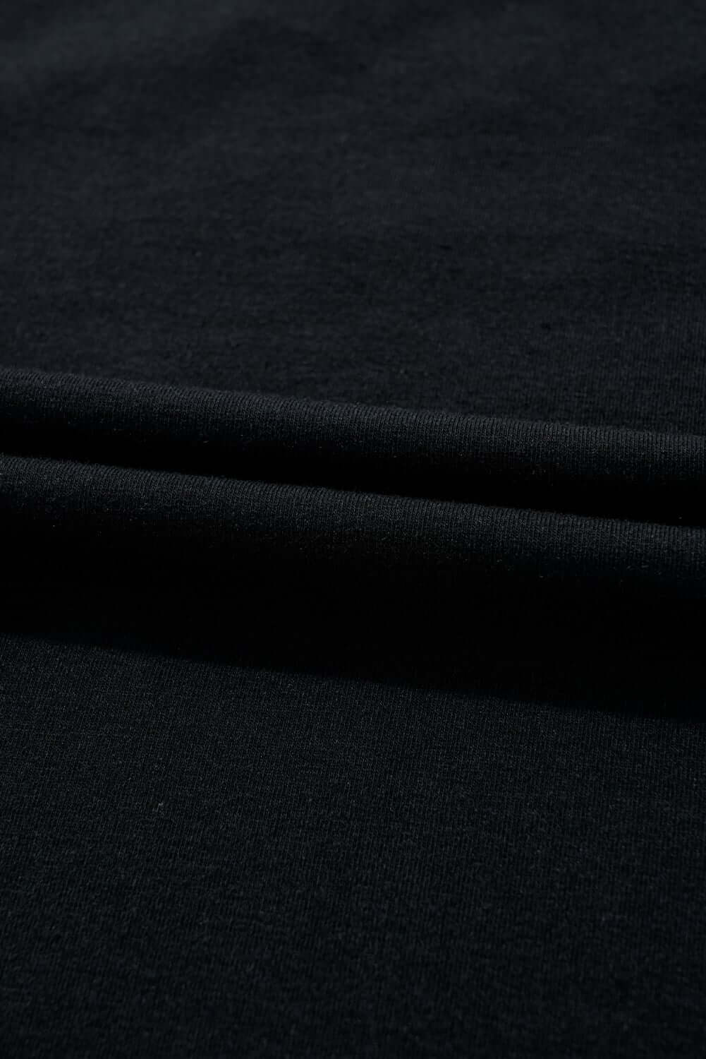 Close-up of soft black fabric showcasing a lightweight cotton blend material, ideal for stylish clothing.