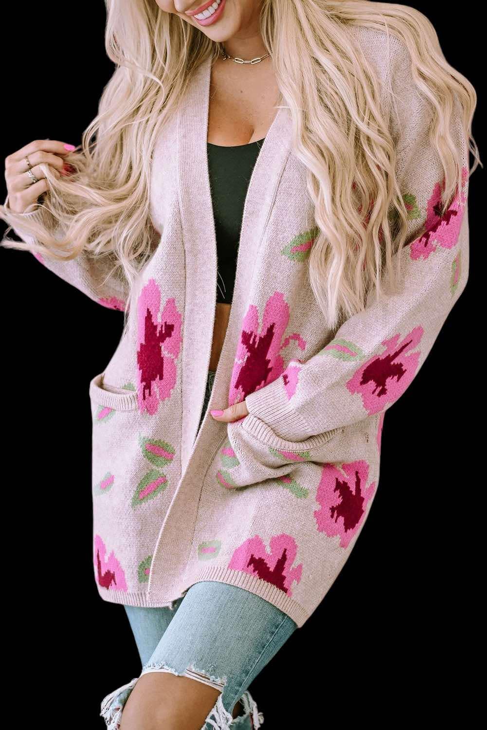 Woman wearing Cardi Girl cardigan with floral pattern and pockets, paired with jeans, showcasing stylish knitwear fashion.