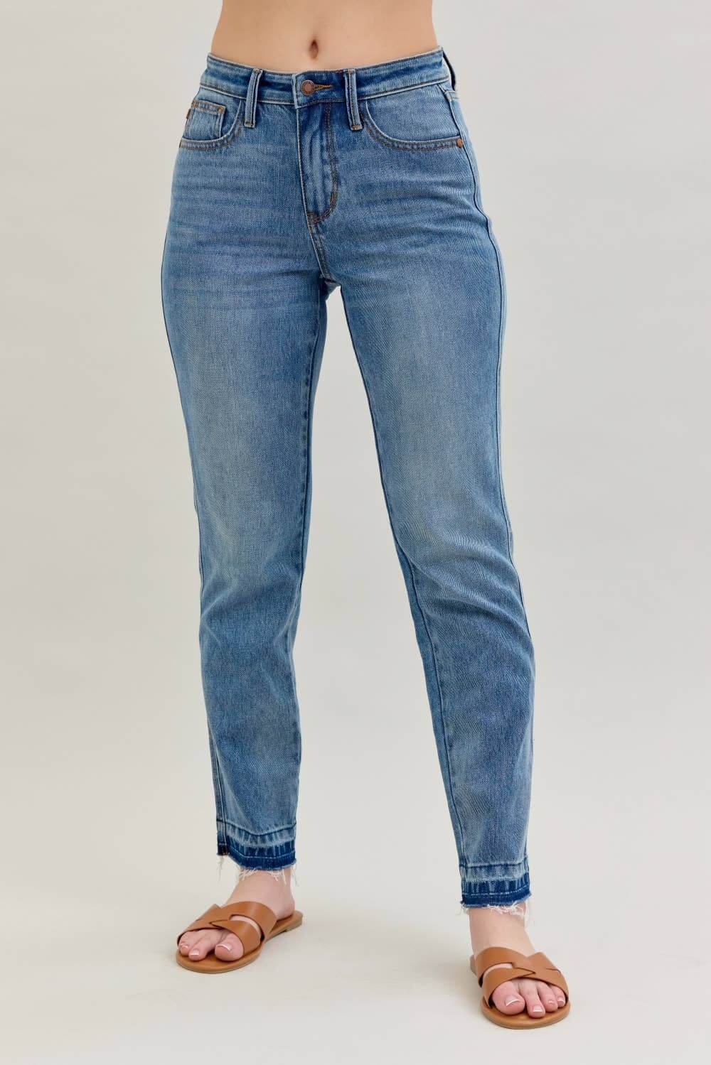 Model showcasing JUDY BLUE - AVERY JEANS in light blue denim with a relaxed boyfriend cut and modern release hem detail.