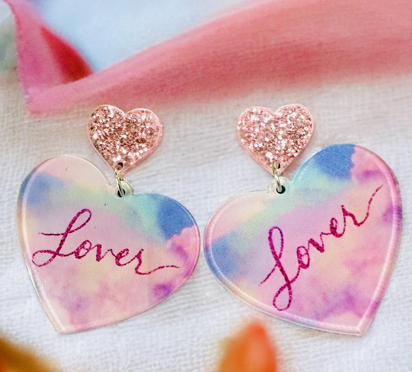Colorful acrylic Lover Era Earrings with heart-shaped pink glitter studs, perfect for making a fashion statement.