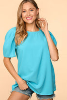 Model wearing the Blue Haven Top by Haptics in aqua, featuring bubble puff sleeves and a relaxed fit.