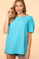 Model wearing the Blue Haven Top by Haptics, a light aqua blouse with bubble puff sleeves and a round neckline.