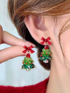 3D Christmas tree earrings with red bows, adding festive style for the holiday season, perfect for women. Size: 1.5 x 0.9 inches.