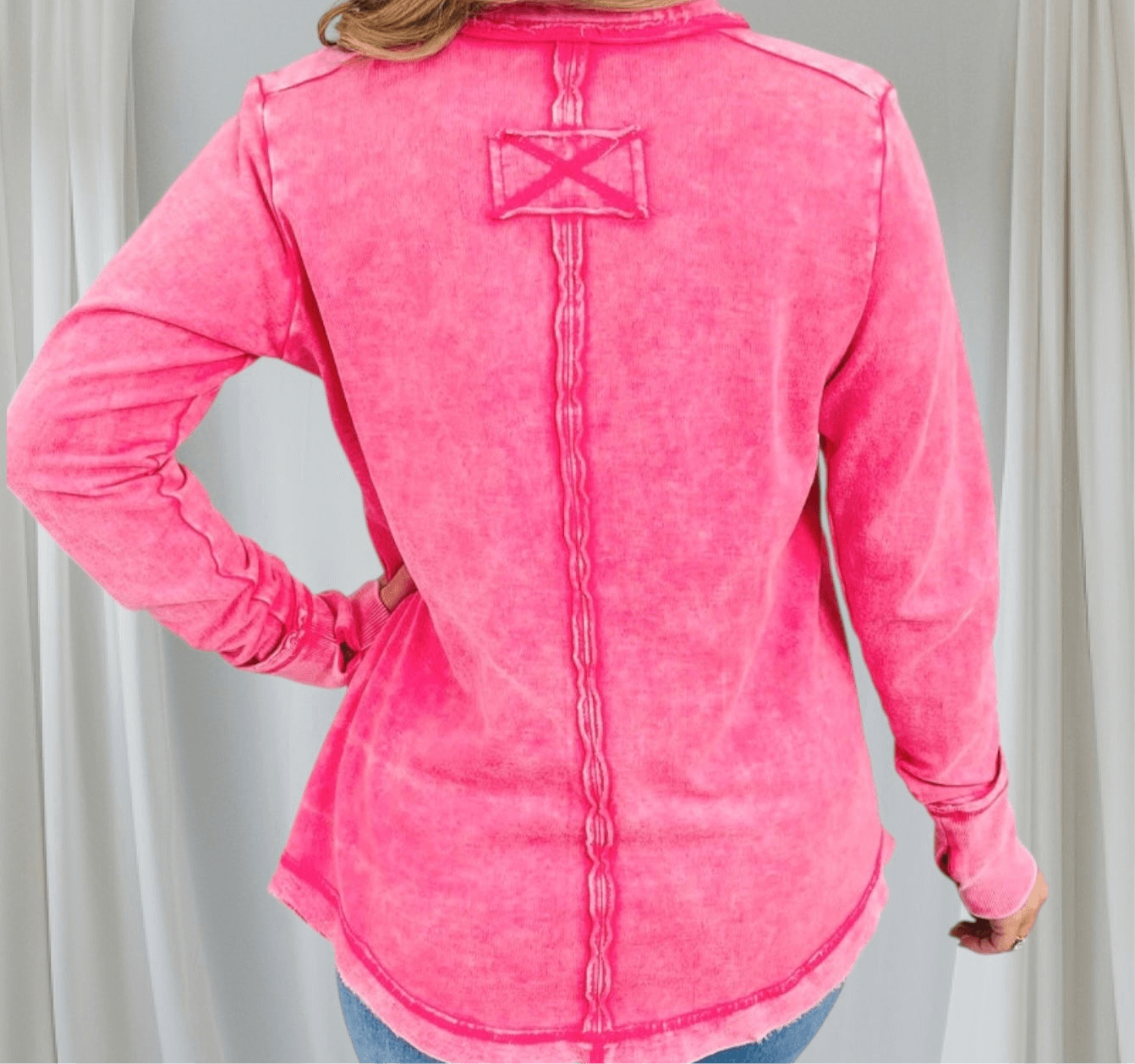 Back view of the Wanderlight Henley Top (fuchsia) featuring a mineral wash and unique raw edge details.