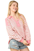 Oversized casual striped knit top in pink and white, featuring a collared design and drop shoulders, perfect for early fall.