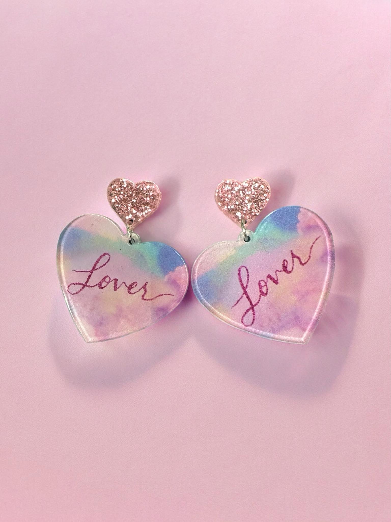 LOVER ERA Earrings: Stunning heart-shaped acrylic earrings with glittery accents, perfect for making a statement.