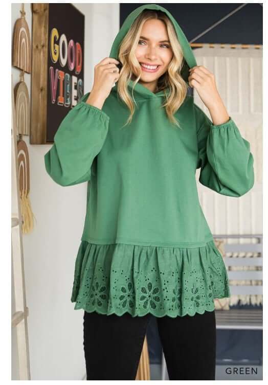 Model wearing green ADVENTURE AWAITS hoodie top with eyelet ruffle by Cotton Bleu.