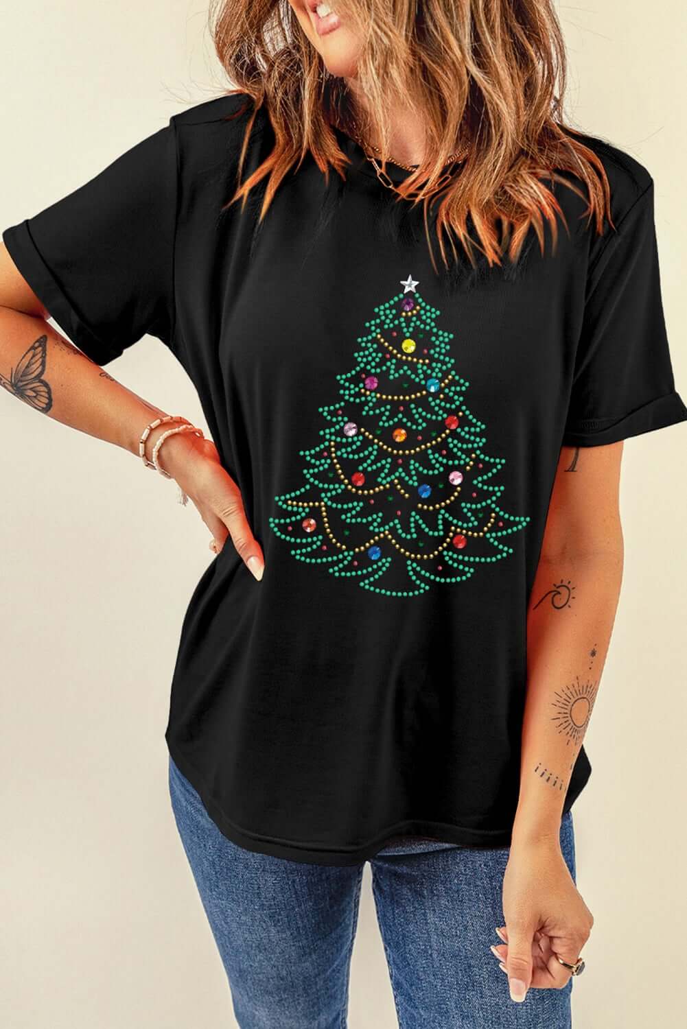 Black t-shirt featuring a studded Christmas tree design, perfect for festive casual wear. Ideal for stylish holiday outfits.