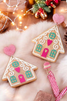 Gingerbread house earrings with colorful details and heart accents, perfect for adding holiday cheer to any outfit.