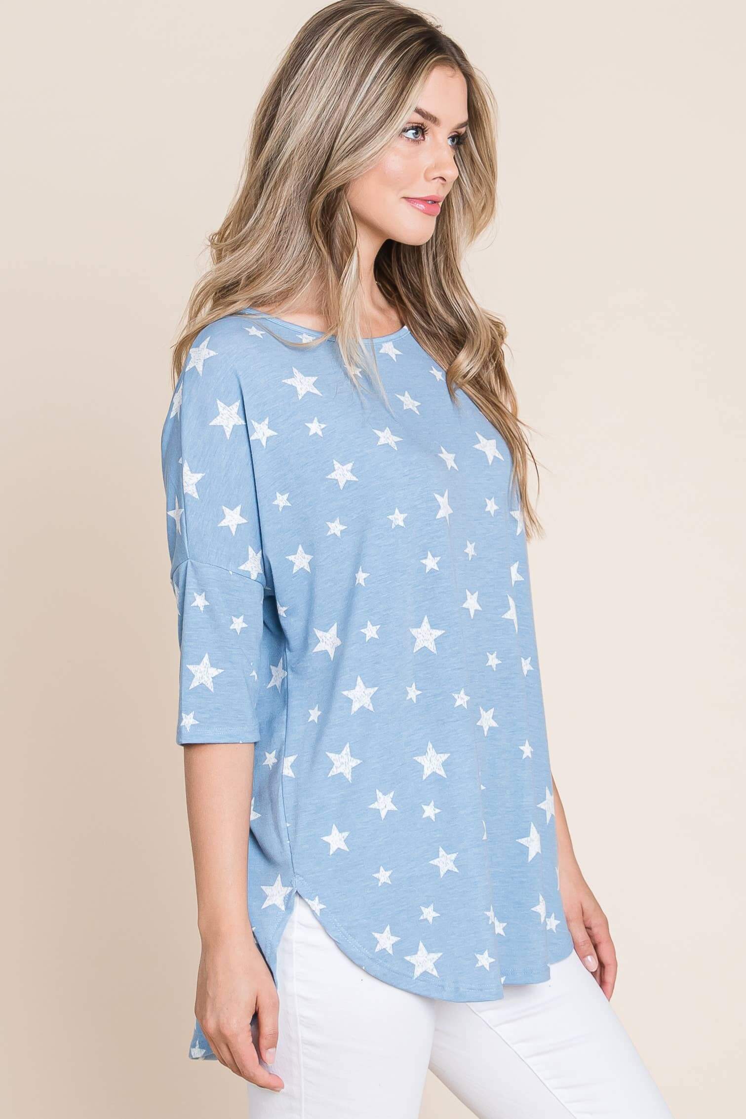 Model wearing a relaxed blue tunic top with a white star print, perfect for casual outings or lounging.
