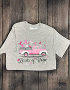 "Loads of Hope T-Shirt with pink truck and ribbons for breast cancer awareness on wooden background"