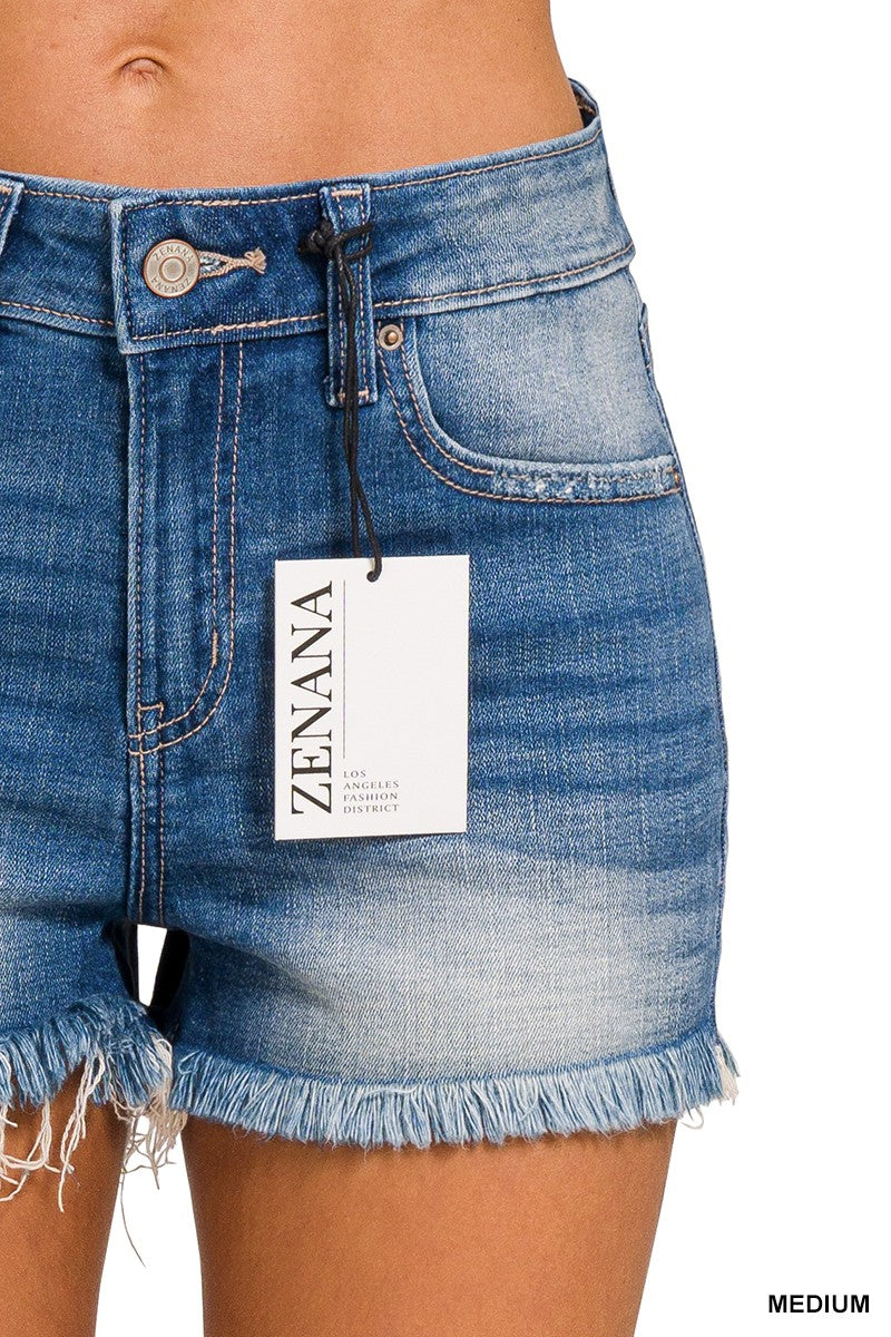 BAREFOOT SUMMER SHORTS by Zenana, medium wash denim with frayed hem, mid-rise fit, showcasing label and button detail.