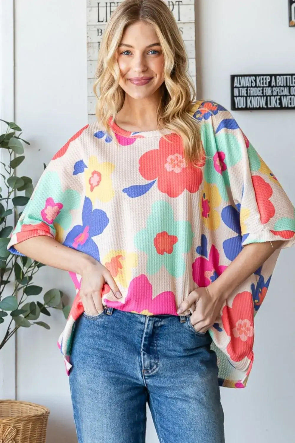 Oversized floral top in vibrant colors, perfect for adding whimsy and style to casual outfits.