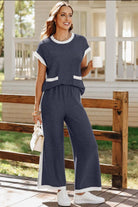 Navy blue Harbor View pants set with cap sleeves and white trim, styled for a coastal chic look.