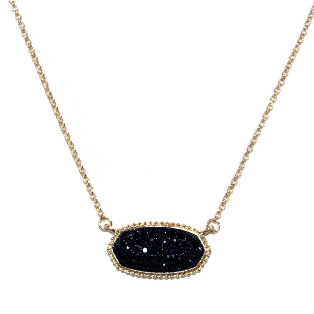 Oval druzy stone pendant necklace with black gemstone, elegant design on a gold chain.