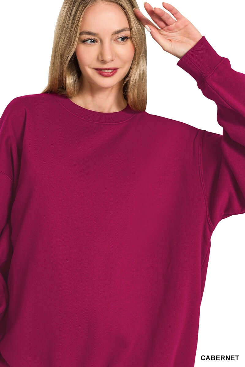 A model showcasing the HEARTHSIDE MOMENTS PULLOVER in vibrant cabernet color, perfect for casual and cozy occasions.