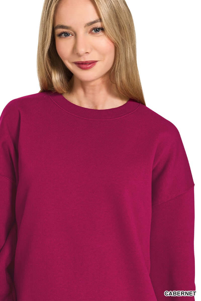 Close-up of a woman wearing a HEARTHSIDE MOMENTS PULLOVER in vibrant Cabernet color, showcasing cozy fleece comfort.
