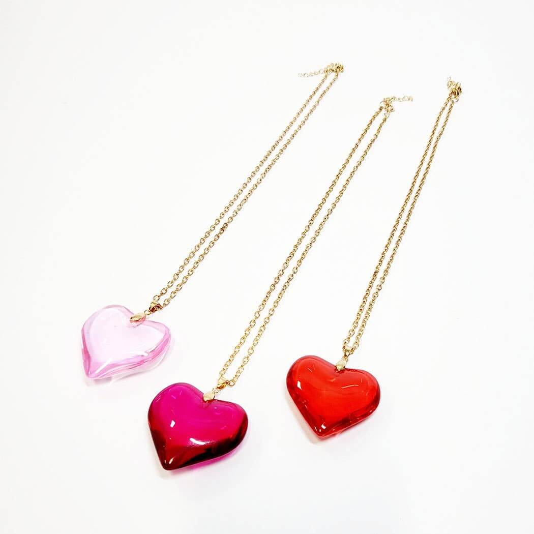 Vibrant heart-shaped pendant necklaces in pink and red, perfect for Valentine's Day gifts. Pack of 12 assorted styles.