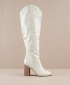 Stephanie White Knee-High Boots by Oasis Society with high heel, slip-on design, perfect for fashion-forward style.