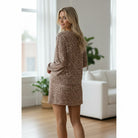 Model showcasing FIERCE COMFORT SKORT SET with leopard print pullover and mini skirt in light French beige.