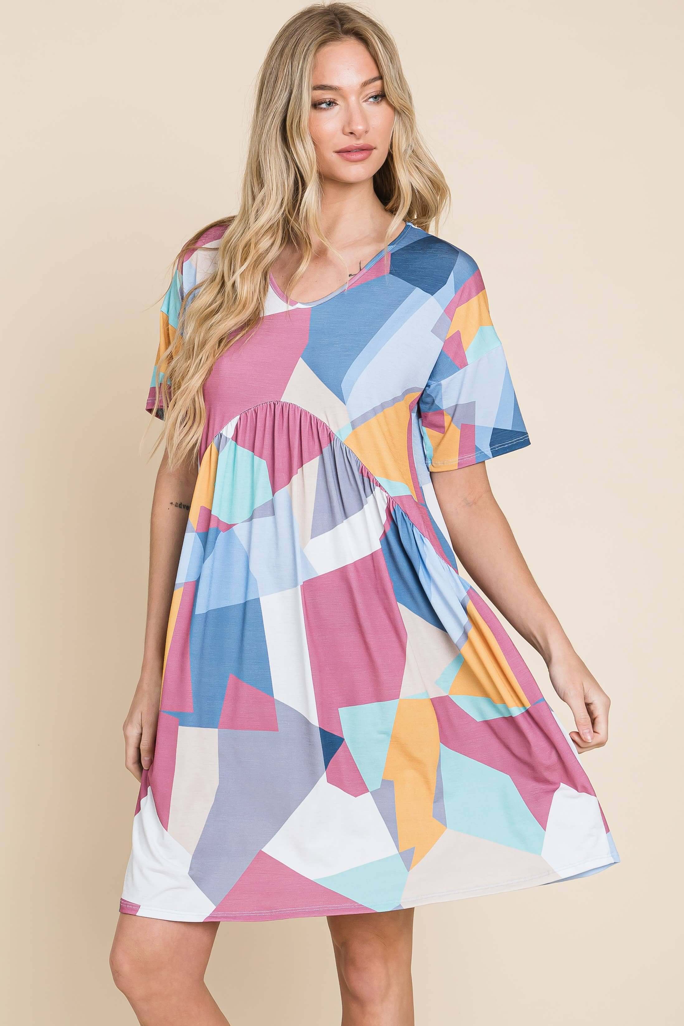 Model wearing DA1519 Shirred Waist Dress with colorful geometric patterns, perfect for a stylish summer look.