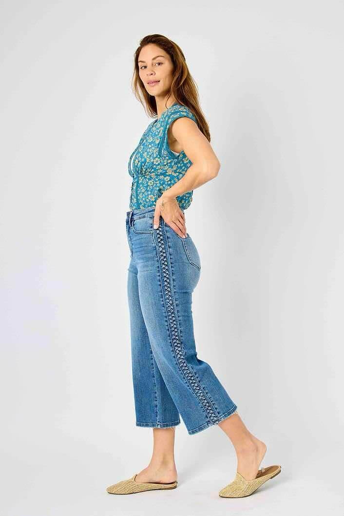 Woman wearing Judy Blue Braided Betty Jeans with braided side detail and wide leg silhouette, adding a stylish twist to a classic design.