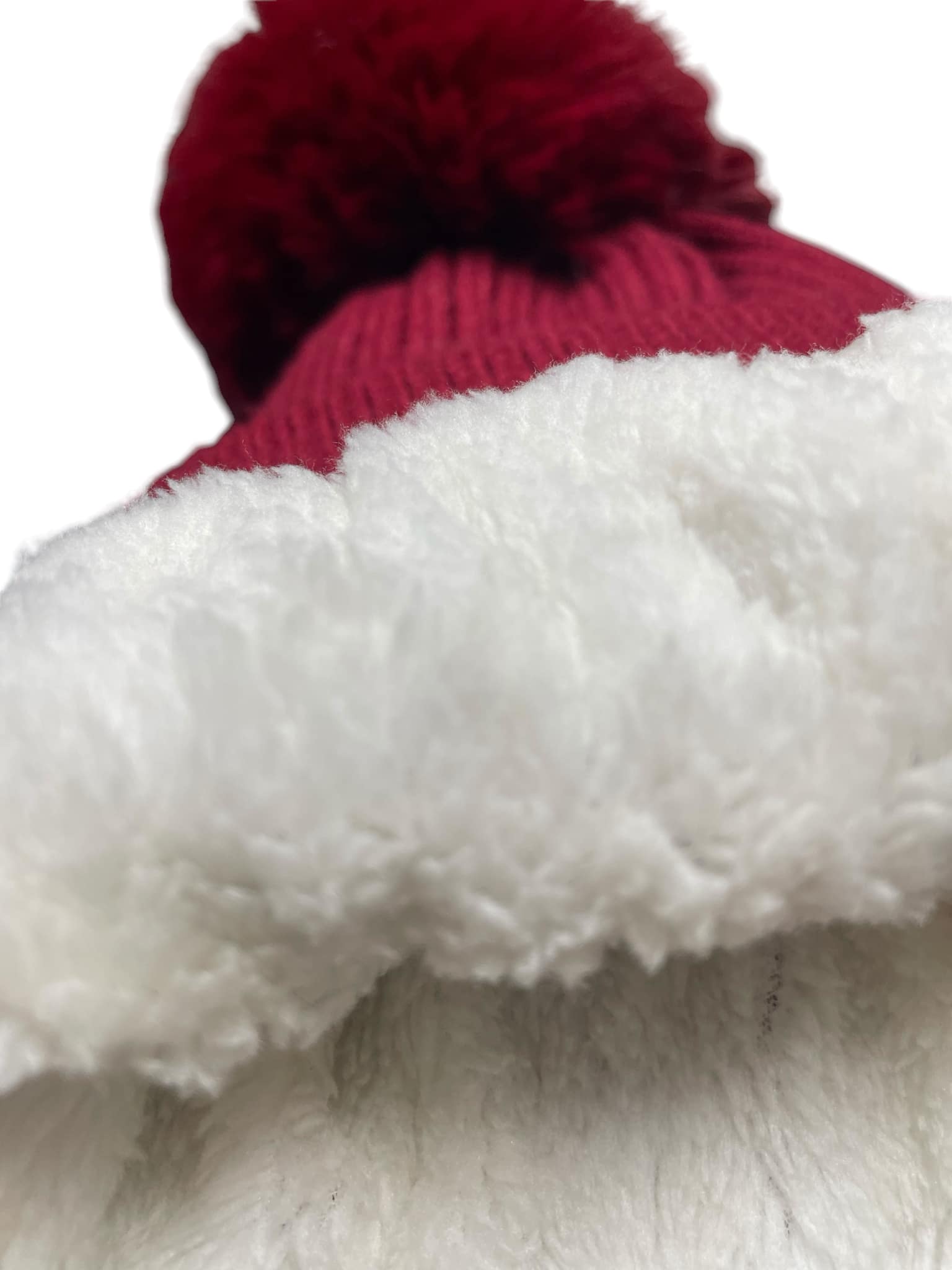 Scarlet Pearl Beanie with cozy sherpa lining and red pom-pom detail, showcasing elegant winter style and warmth.