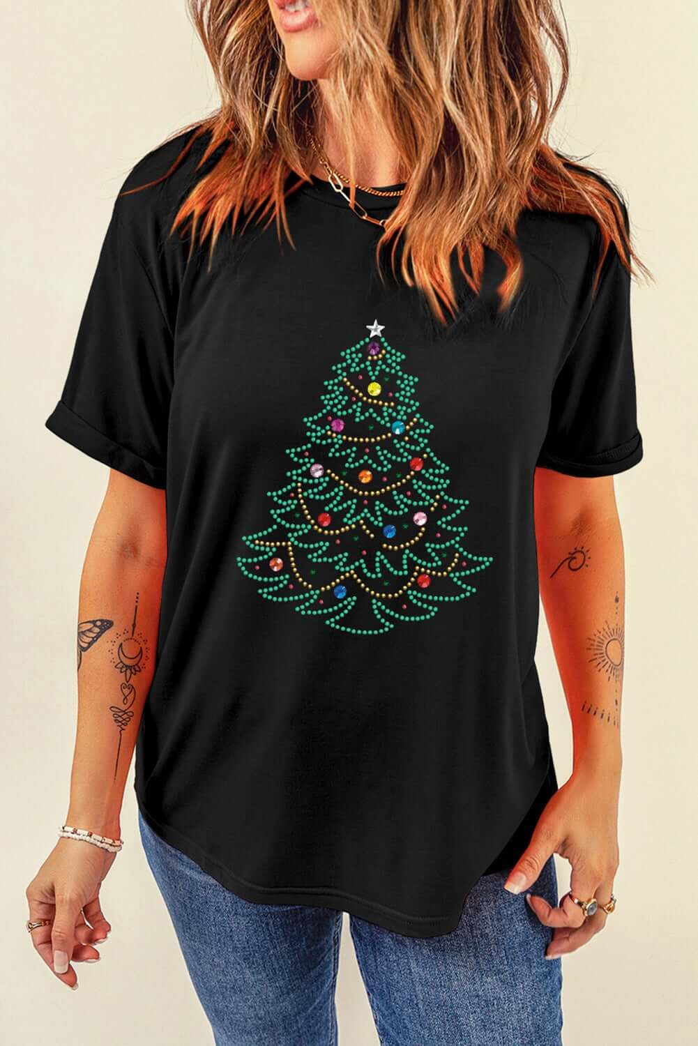 Black t-shirt with studded Christmas tree design, perfect for festive fashion and versatile styling.