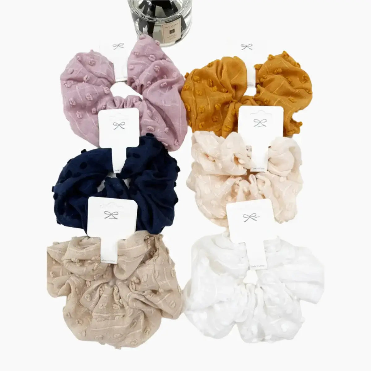 Colorful Cloud Comfort Scrunchies in pompom texture - 6 stylish options for hair and wrist wear.