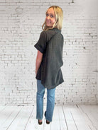 Woman wearing the Midnight Mist top from Umgee, showcasing its V neckline and frayed hem.