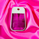 ASHLEY LAURA XL STRAWBERRY HAND SANITIZER in a vibrant bottle on soft pink satin fabric.