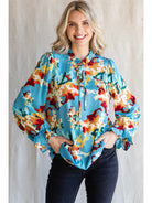 Woman wearing a vibrant Pure Poetry Top with a self-tie neck and poet sleeves by Jodifl.