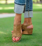 Tan Corky's Carley Studded Wedges on a model, showcasing style and comfort with a slingback design and cork heel.