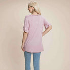 Back view of soft pink Delicate Directions V-Neck Lace Trim Top with ruffled sleeves and relaxed fit.
