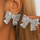 SPARKLING BOWS Earrings featuring shimmering rhinestones, perfect for adding glamour to any outfit.