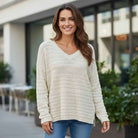 FREE FLOW - Adora cream knitted sweater model smiling outdoors