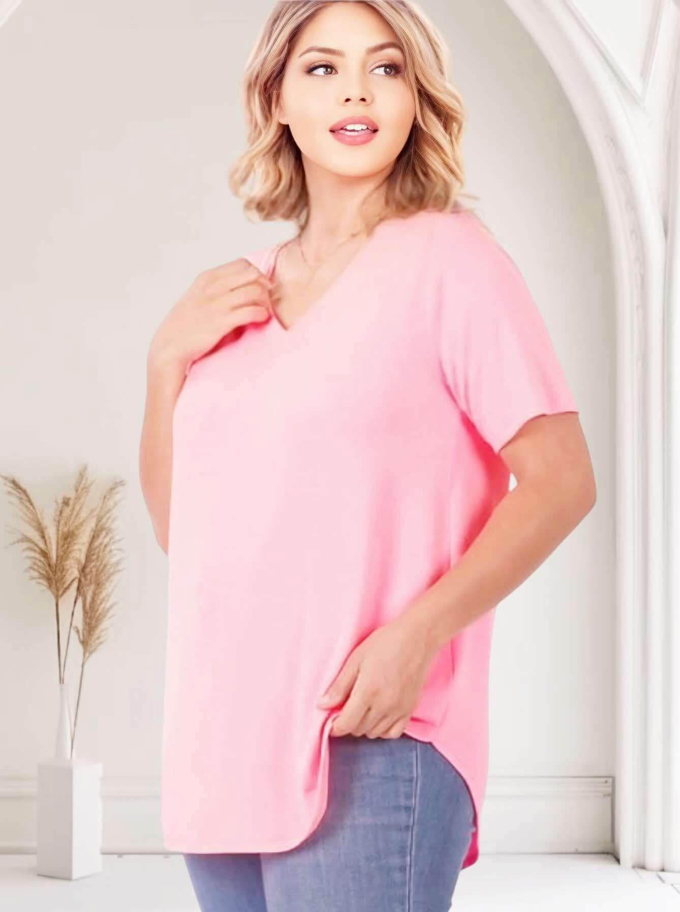 Model wearing the Softest Rose Tee by Zenana, a comfy plus size v-neck top in soft pink.